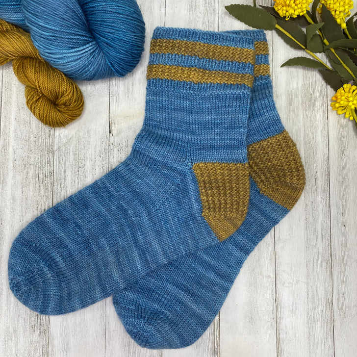 Indulge in cozy comfort with a pair of Twice As Rice socks that incorporate a rice-textured heel and striped cuff in a coordinating pop of color, adding an unexpected element to your everyday attire.