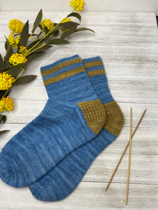 Indulge in cozy comfort with a pair of Twice As Rice socks that incorporate a rice-textured heel and striped cuff in a coordinating pop of color, adding an unexpected element to your everyday attire.