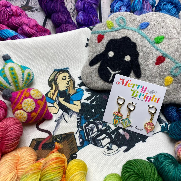 The 2023 yarn advent from Wonderland Yarns included fun surprises like a stitch marker set, felt notion bag, project bag, and felted ornaments!
