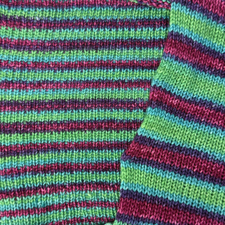 #1 You Had Me at Hello, a self-striping sock yarn featuring a bright spring green with magenta and blue stripes