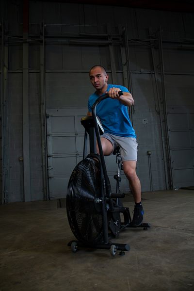A person using indoor exercise bikes in training at home.