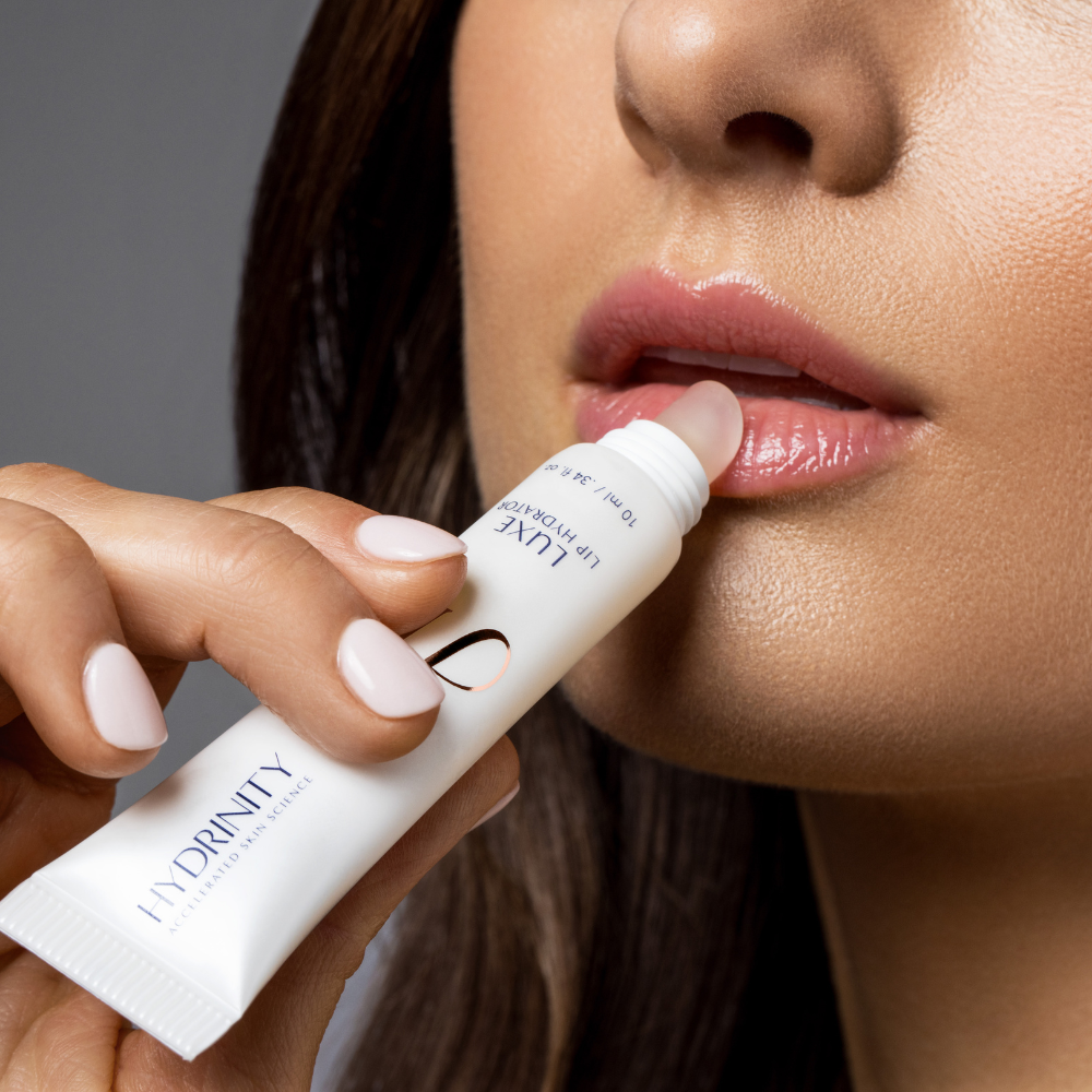 Hydrinity Luxe Lip Hydrator Being Applied To A Woman's Lips