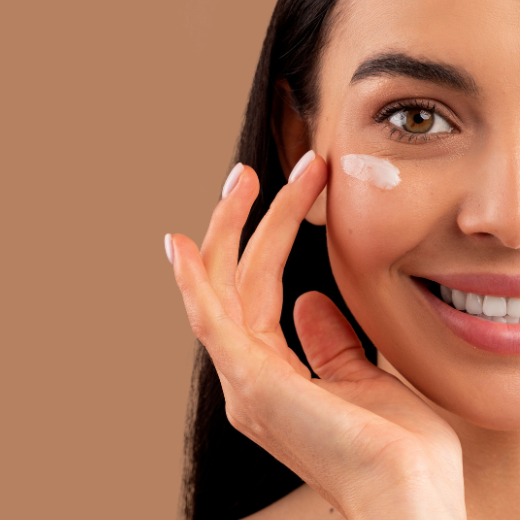 Woman applying eye cream to eyes to treat dark circles under the eyes