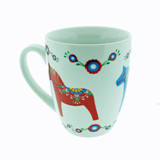 White ceramic mug with red and blue Dala horse designs and floral accents.
