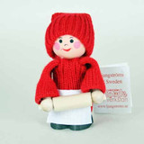 A small wooden Swedish tomte girl figurine with a red knit hat and sweater, white apron, and rolling pin.