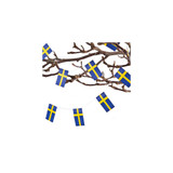 Paper Swedish flags on a string draped on branches.