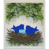 A blue bird nest design on a white Swedish dishcloth with pine branches.