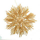Handmade 7-inch Scandinavian straw star ornament with intricate woven details, photographed from above on white.
