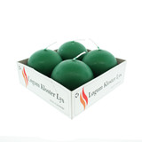 Four green spherical candles in a white branded box, angled view.