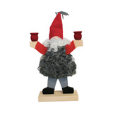 Handmade Swedish wooden candleholder shaped like a gnome in a vest and red hat, holding two red candle cups.