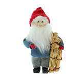 Scandinavian Tomte figurine in blue sweater, grey pants, and red hat holding a straw goat.