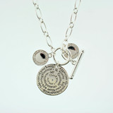 Silver necklace with round pendant and crystal charms.