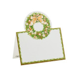 Folded place card with a seashell wreath and gold ribbon, bordered by greenery.