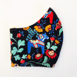 Handmade black cotton face mask featuring a colorful Swedish Dalahorse pattern.