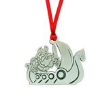 Pewter Viking ship ornament with a horned warrior holding a sword, hanging from a red ribbon.