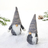 Set of two Pobra fabric gnomes in grey knit hats and white beards on snow.