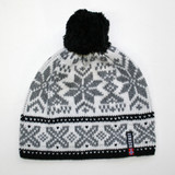 White, grey, and black knit hat with snowflake pattern and black pom-pom.