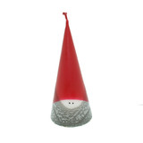 A red and gray cone-shaped Tomte candle with small black eyes, on a white background.