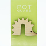 A wooden hedgehog-shaped pot guard on light green packaging with white text.