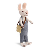 Handmade white felt bunny figurine wearing blue pants and a tiny tan shoulder bag.