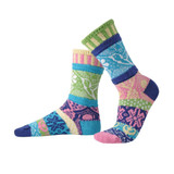 Two colorful, mismatched crew socks with patterns of hummingbirds in turquoise, pink, green, and purple.