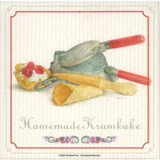 Swedish dishcloth with Timothy Trost's Homemade Krumkake illustration showing krumkake iron, rolled cones, berries, and text.