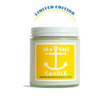 A 4 oz. glass candle jar with a white lid and bright yellow label featuring a white anchor illustration.