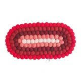 Oval wool felt ball trivet in shades of red and pink, featuring a loop for hanging.