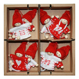 Four pairs of red-hatted wooden tomte boy and girl ornaments in a cardboard box.