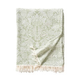 Green and white William Morris-patterned cotton throw blanket with fringe, folded.
