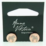 Rose gold stud earrings featuring crystal-embellished Dala horses, mounted on a black Anna Viktoria display card.