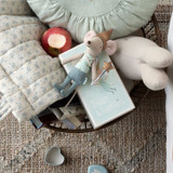 Maileg tooth fairy boy mouse in blue pants and shiny hat lying on matchbox.