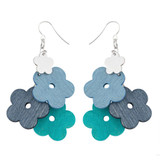Aarikka Kukkaniitty dangle earrings featuring stacked wooden flower pendants in light blue, dark blue, and turquoise.