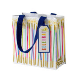 Small white gift bag featuring colorful candles, blue rope handles, and a "Celebrate" tag.