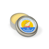 Silver tin of Swedish Dream Lemon Lip Balm, open, showing yellow balm. Blue, red, and yellow label.