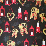 Christmas wrapping paper with red lanterns, straw goats, and candles on black background.