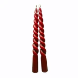 Two wine red twisted taper candles linked by their wicks against a white background.
