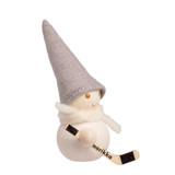Handcrafted wooden Aarikka elf figure wearing a grey felt hat and white scarf, holding a miniature hockey stick.
