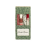Four Christmas candles in a box: candy cane, reindeer, holly, and Santa.