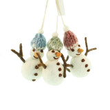 Three handmade felt snowman ornaments with knit hats in blue, green, and pink, hanging together.