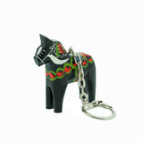 Black wooden Dala horse key ring with traditional painted red, green, and white patterns.