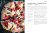 Pizza with cured pork, wild strawberries, and goat cheese, cut into slices.