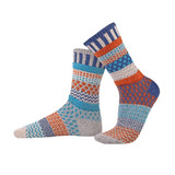 Two mismatched Solmate Socks in Mirabell colorway. Crew height, knit with various patterns in blue, orange, and gray.