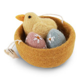 Yellow felt chick and eggs in a felt nest. Pink and blue eggs with white flower details.