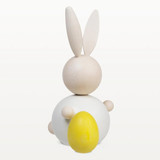 White wooden rabbit figurine with yellow egg, maple, handmade.