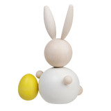 Wooden white rabbit figurine holding a yellow egg; maple wood.