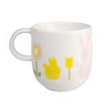 White ceramic mug with spring bunny and flower designs.
