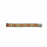 Flatlay of red Sami braid bracelet with geometric embroidery and silver button.