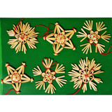 Six straw star and snowflake ornaments on green background; natural straw color, red string.