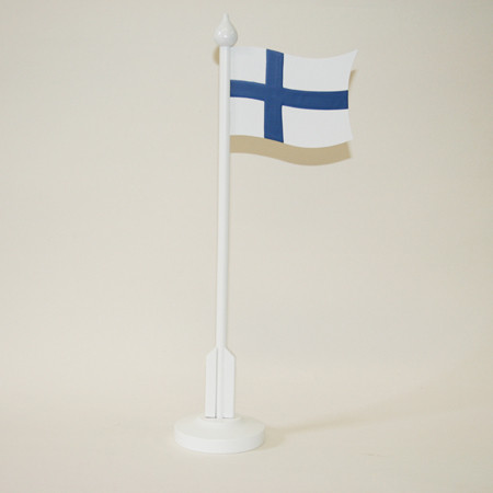 White table flag pole with Finland flag on a light background.